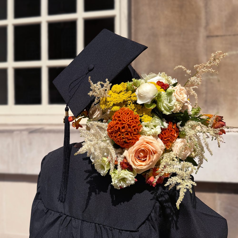 Graduate holding a So Stellar bouquet