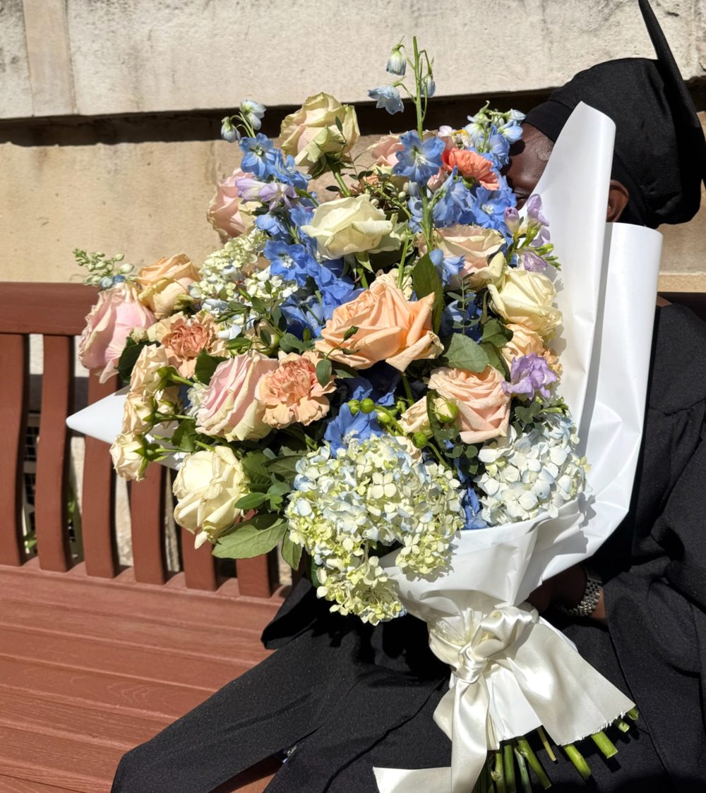 Graduate holding a bouquet