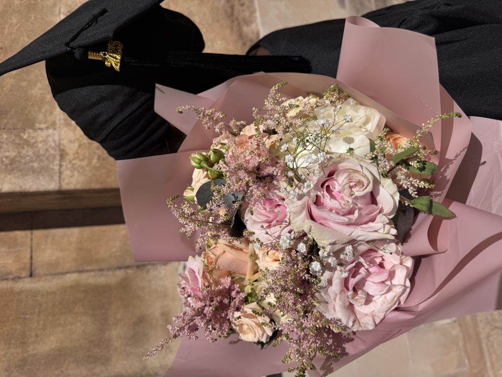 Graduate with a pink bouquet